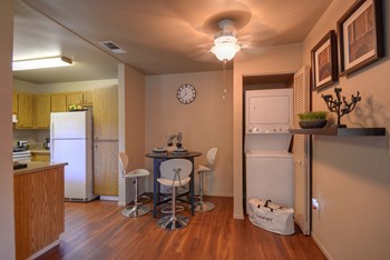 Dining Area with Wood Inspired Floor, Washer/Dryer, Refrigerator, Ceiling Light
